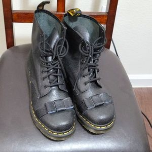 Black Dr. Martens combat boot with bow .
